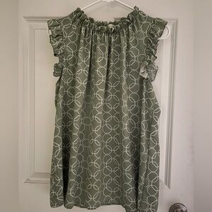 Beautiful ruffle shoulder l, sleeveless top. Fits a bit longer